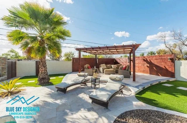 Composite patio with pergola, synthetic turf, lounge seating, and palm trees