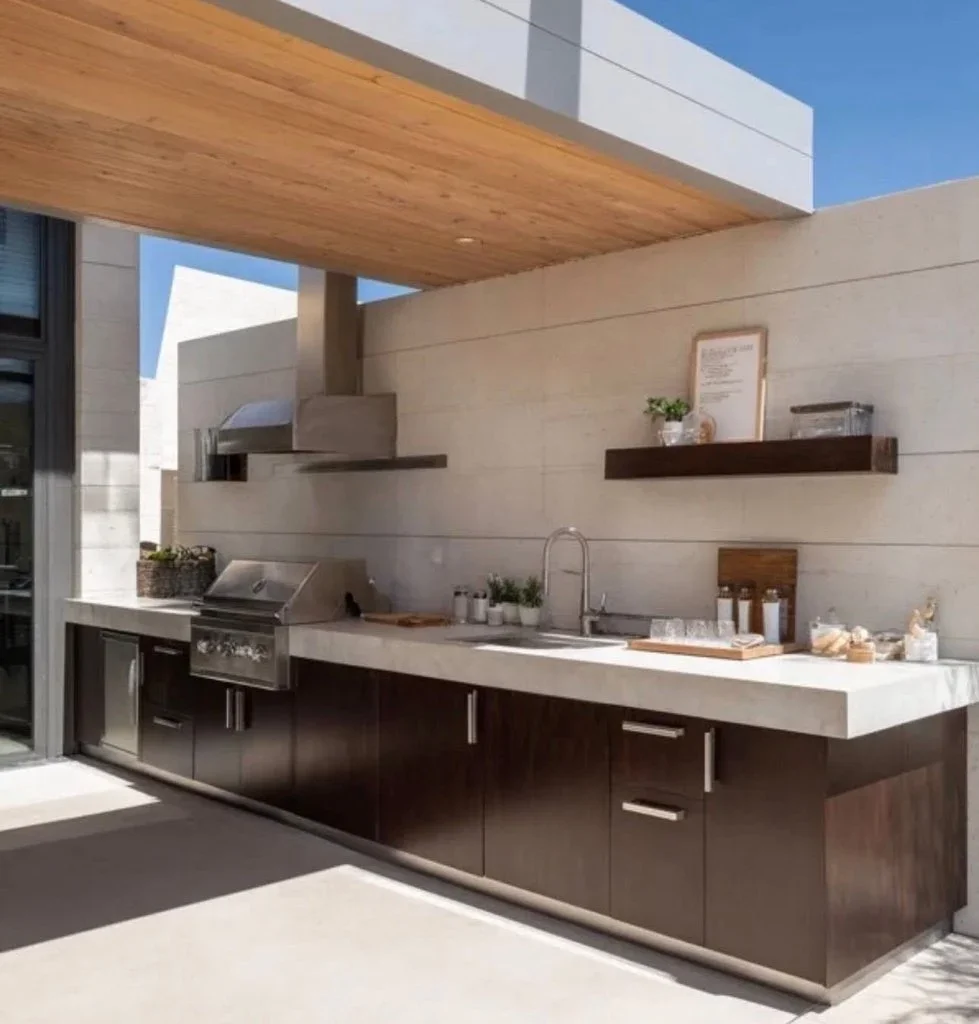 Outdoor kitchen with dark cabinets, quartz countertop, stainless steel grill, and wood pergola ceiling